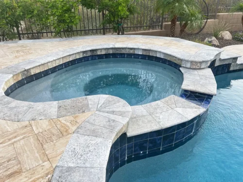 Spillover spa integrated into a freeform pool
