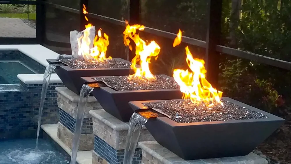 Close-up of fire bowls and water features for custom built geometric pool and spa