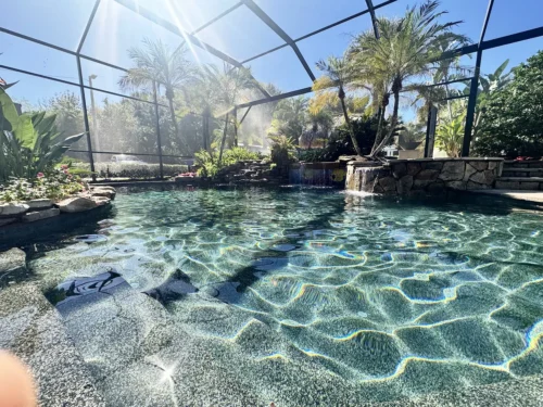 Close-up of the gorgeous PebbleTec finish applied to a freeform, lagoon style pool and spa.