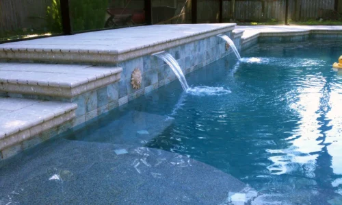 Close-up of water feature and sun shelf for a new, custom built pool