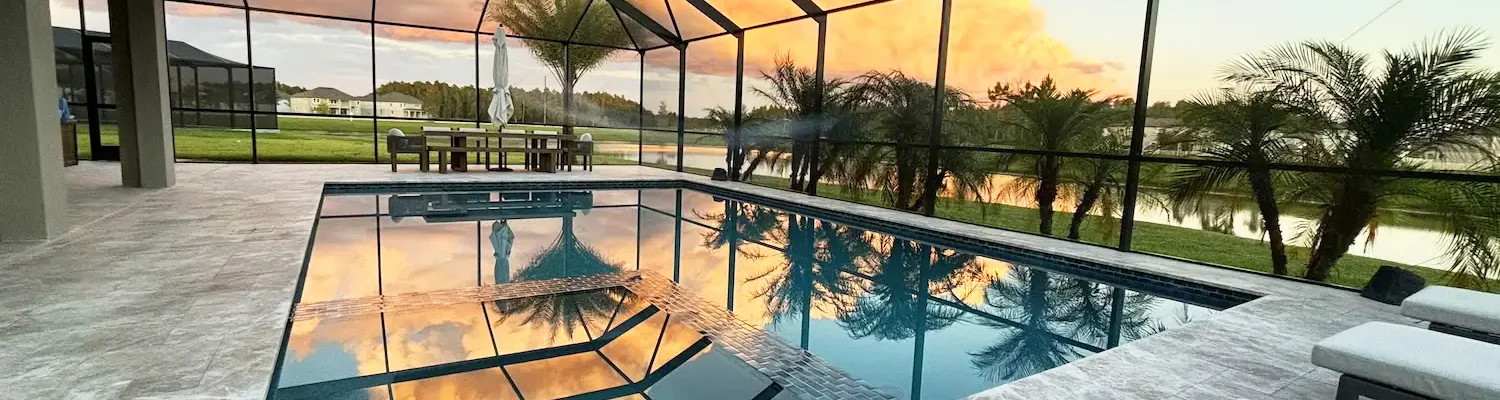 Custom built geometric pool & spa inside screen enclosure.