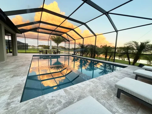 Custom built geometric pool & spa inside screen enclosure.