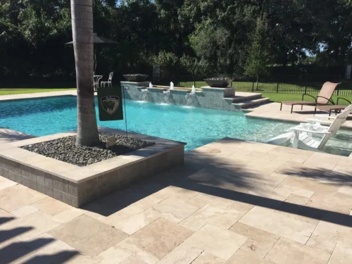 Custom built geometric pool with fire bowls, water bubblers & cascades, sun shelf, & planter.