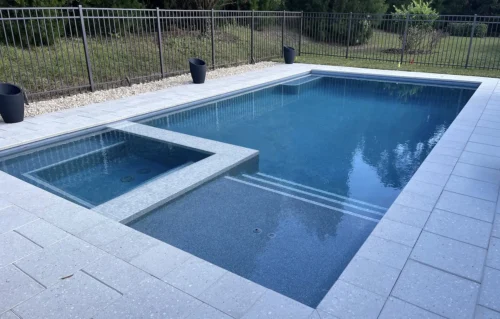 Custom built geometric pool with spa & sun shelf.