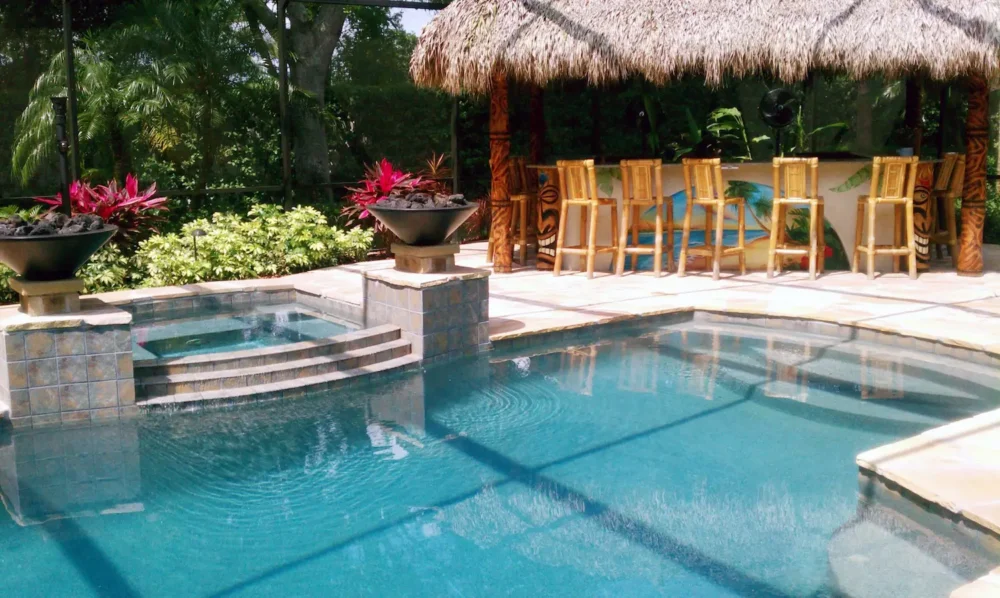 Custom built geometric pool with spillover spa & fire bowls.