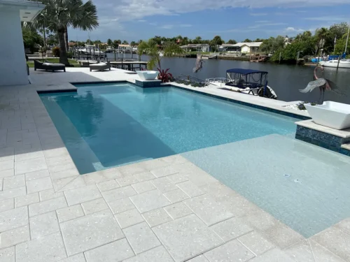 Custom built geometric pool with sun shelf & fire bowls.