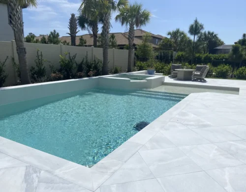 Custom built geometric pool with sun shelf & spillover spa.
