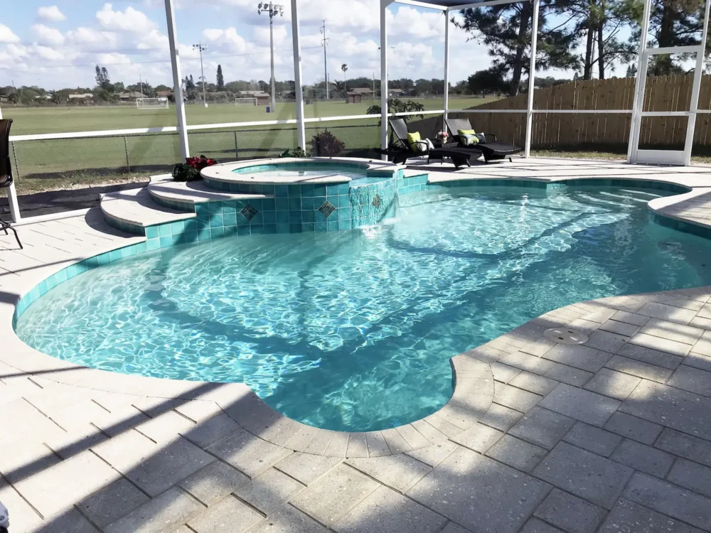 Custom freeform pool with spillover spa