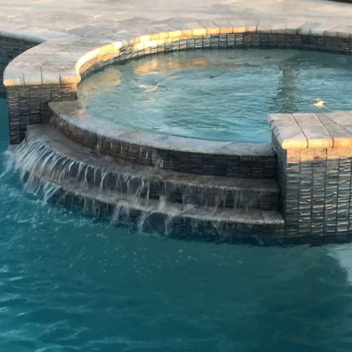 Custom spillover spa integrated into a freeform pool