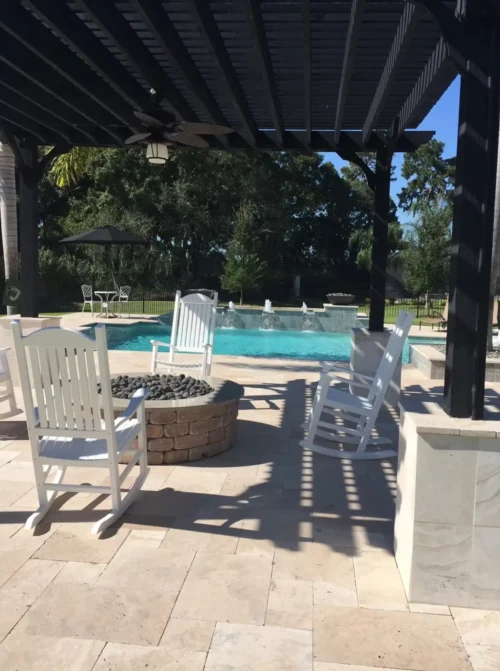 Fire pit under pergola with geometric pool in the background