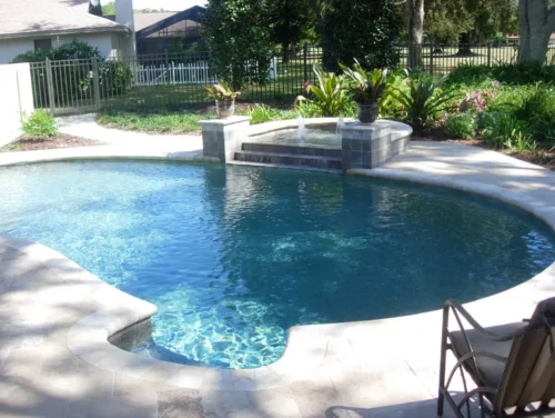 Freeform pool with spillover spa and bubblers