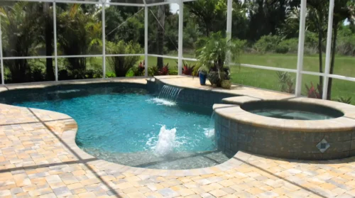 Freeform pool with spillover spa and multiple water features