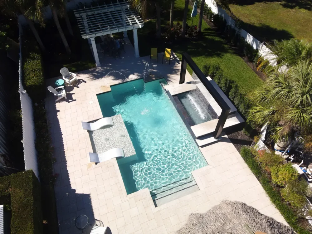 Geometric pool with Integrated fire & water features and a sun shelf (tanning ledge).