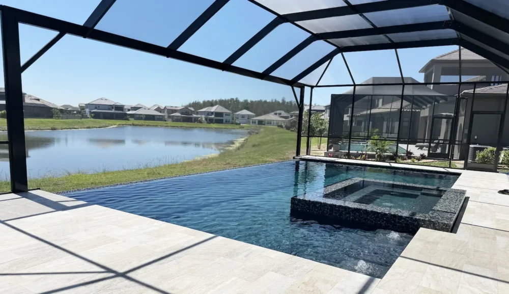 Geometric pool with spa & water bubblers inside screen enclosure.