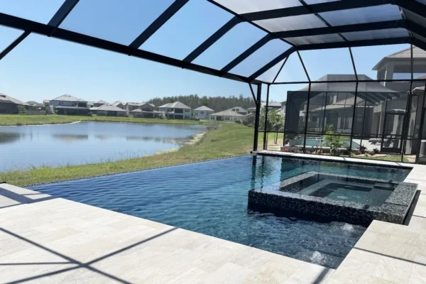 Geometric pool with spa & water bubblers inside screen enclosure.