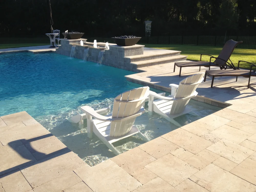 Geometric pool with sun shelf, fire bowls, and water features