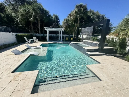 Geometric pool with sun shelf, fire & water features, pergola, and seating area.