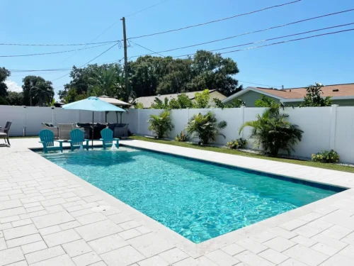 Geometric pool with sun shelf for lounging.