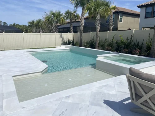 Geometric pool with sun shelf & spillover spa .