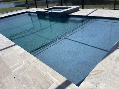 Geometric pool with sun shelf & spillover spa.