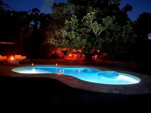 Night view of freeform pool with LED lighting