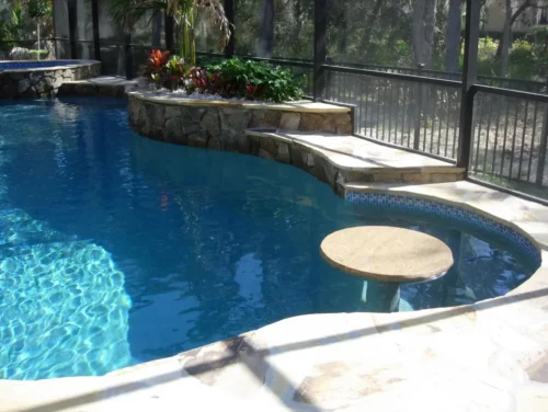Planter and table for custom built freeform pool and spa. Custom pool builder company is Gulfstream Pools & Spas.