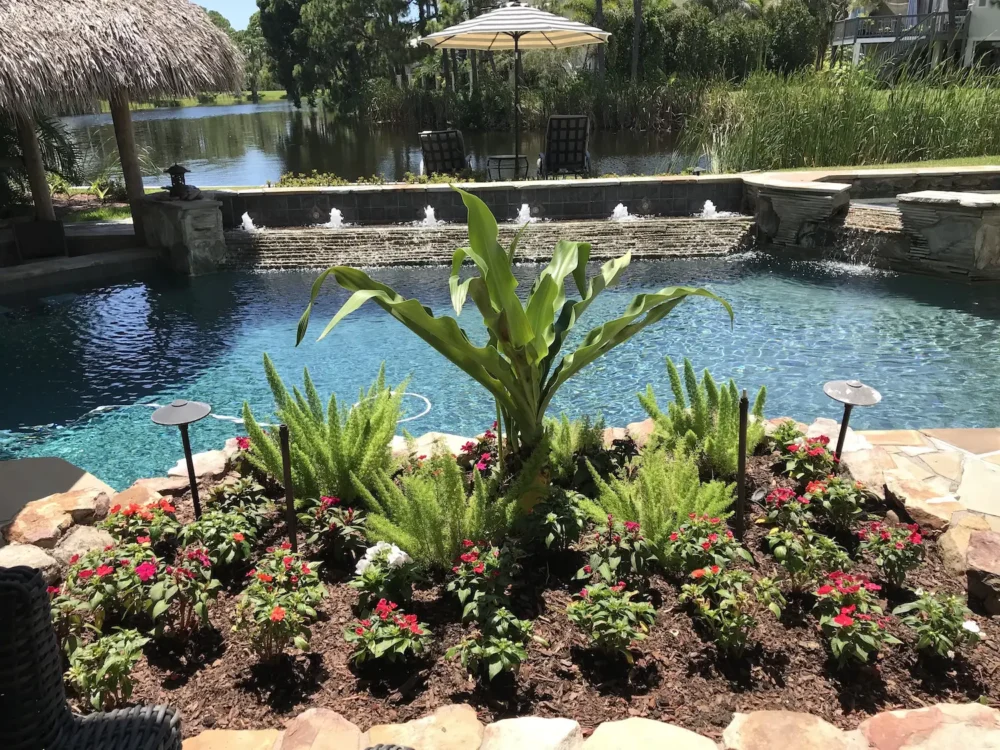 Planter for custom built pool with multiple water features, swim-up bar, and spillover spa