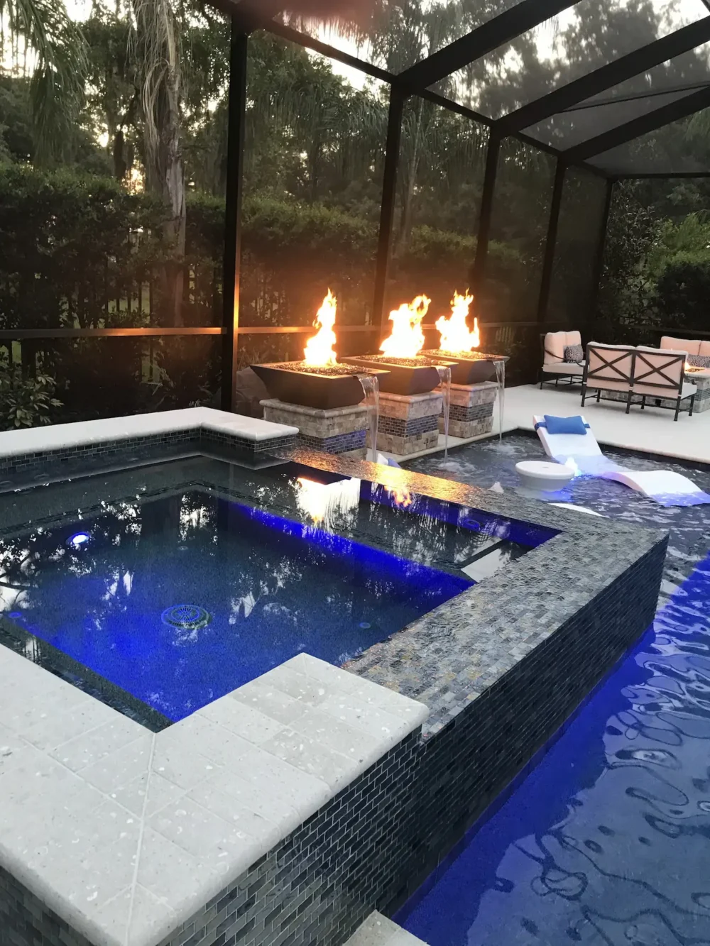 Spa, fire bowls, water features, and sun shelf for a custom geometric pool