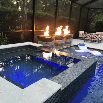 Spa, fire bowls, water features, and sun shelf for a custom geometric pool