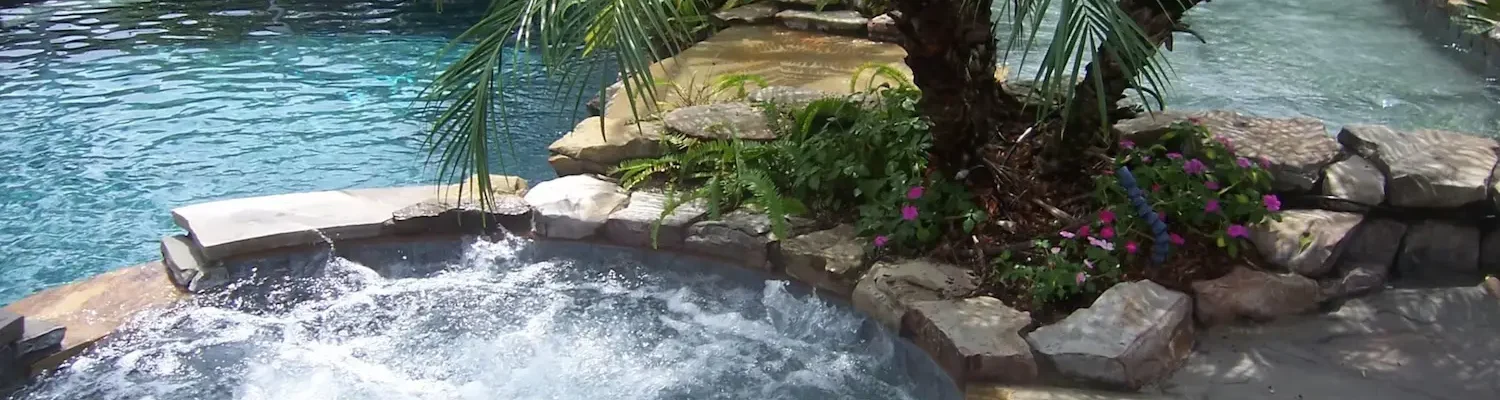 Two spas integrated into a freeform pool with planters.