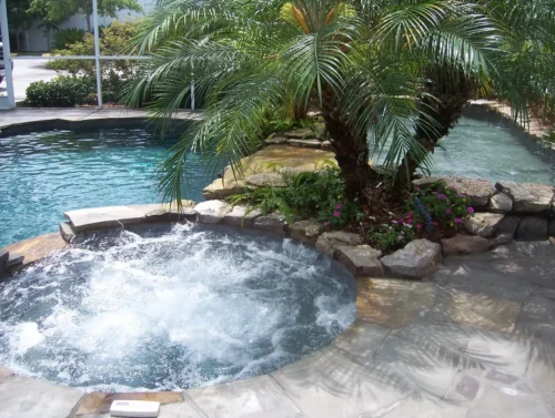 Two spas integrated into a freeform pool with planters.